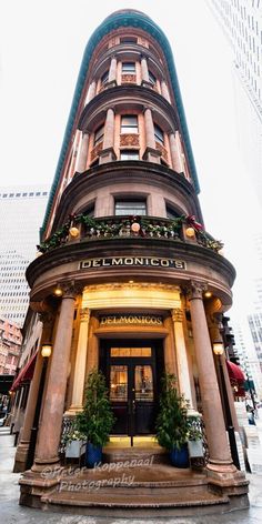 the front entrance to an elegant hotel in new york city, with potted plants on either side