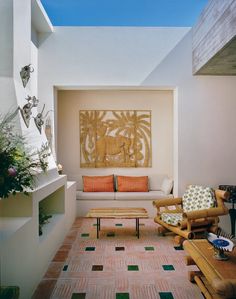 a living room filled with lots of furniture and decor on top of tiled flooring