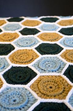 a crocheted blanket with circles on it