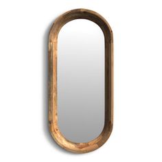 an oval wooden mirror hanging on the wall next to it's reflection, with a white background