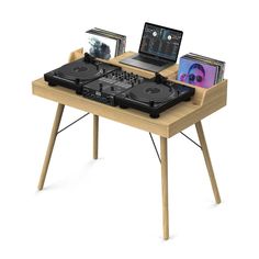 a laptop computer sitting on top of a wooden table with dj's and turntables