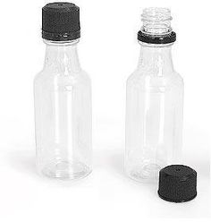 an empty glass bottle with a black lid and a smaller one on the side that has a rubber cap