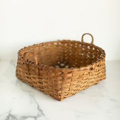 a brown basket sitting on top of a white counter