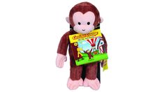 a stuffed monkey is holding a book in its hands