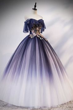 a blue and white dress with flowers on the back, sitting on a mannequin