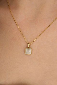 Sparkle with sophistication in this elegant Trendy Cornered Square Pendant Necklace. Crafted in luxurious 14k gold, this pendant features a dazzling zircon stone that captures the essence of timeless beauty. The unique cornered square design adds a modern touch to this classic piece, making it a versatile accessory for any occasion. Whether you're dressing up for a special event or elevating your everyday look, this necklace exudes charm and style. Elevate your jewelry collection with this exqui Elegant Diamond Necklace With Rectangular Pendant, Luxury Gold-plated Necklaces With Pave Setting, Luxury Gold-plated Necklace With Pave Setting, Gold Plated Necklaces With Pave Setting For Gift, Gold Plated Pave Setting Necklace For Gift, Yellow Gold Square Pendant Diamond Necklace As A Gift, Gold Diamond Necklace With Rectangular Pendant As A Gift, Gold Diamond Necklace With Rectangular Pendant Accents, Luxury Yellow Gold Diamond Necklace With Square Pendant