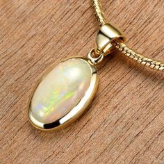 Yellow Iridescent Opal Necklace Gold 10K Bezel Pendant Australian Opal Chain Necklace FEATURES: * Solitaire Oval Pendant * White Opal, Mintabie, South Australia * Everyday 10K Gold Pendant * Minimalist Styling * Lifetime Warranty * Flexibility Shipping Services & Free over $500 * Shipped with Insurance & Tracking * Authenticity Certified * Completely Handmade OPAL DETAILS: Number of Opals: 1 Opal Type: White Opal Total Carat Weight (cwt): 1.69 Overall Dimensions (mm):11.61 x 6.73 x 3.43 Shape: O Luxury Yellow Gold Opal Jewelry, Luxury Opal Necklace With 17 Jewels, Yellow Gold Cabochon Necklace For Anniversary, Anniversary Yellow Gold Cabochon Necklace, Formal Opal Necklace With 17 Jewels, Formal Round Opal Necklace, Luxury Gold Opal Jewelry, Formal Opal Round Necklace, Luxury Yellow Gold Opal Necklace