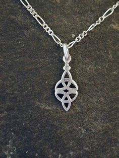 "This Celtic Eternal Love pendant is Sterling Silver. The included chain is a Sterling Silver Figaro 50 chain. You may choose 16, 18 or 20 inch at the same price. Other length available at sightly higher prices. This Celtic Eternal Love pendant measures 13/16\" long by 5/16\" across. I hand cast all my pieces using the lost wax casting method. Please ask your needs. You may call me with questions, often I am out so please use my machine. 831-476-3176. Satisfaction Guaranteed! I send items USPS F Symbolic Silver Necklace With Delicate Chain, Nickel-free Link Necklace For Gift, Love Pendant, Elephant Head, Wax Casting, Lost Wax Casting, Lost Wax, Hand Cast, Eternal Love