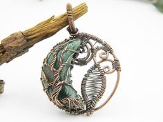 You will receive 1 pcs of Green aventurine pendant Copper Wire Filigree Art Wire Wrap Pendant Natural Genuine Gemstone Pendant. Stone : Green aventurine Pendant Size : 46 mm long include bail Many thanks for you visit my store ♥ if you have any question please contact us. For wholesale Price Please Convo me. You can order different items as many you like . Artisan Jewelry Making Moon Charm, Artisan Moon Charm Jewelry For Jewelry Making, Green Moonstone Jewelry Gift, Nature-inspired Round Pendant Jewelry With Moon Charm, Wire Wrapped Aventurine Jewelry For Gifts, Handmade Aventurine Round Necklaces, Bohemian Aventurine Pendant Jewelry, Spiritual Hand-wrapped Aventurine Jewelry, Nature-inspired Round Jewelry For Crafting