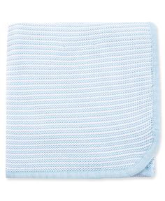 the light blue knitted blanket is folded