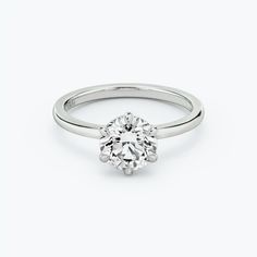 a white gold engagement ring with a round diamond