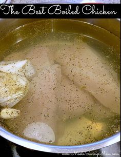 the best boiled chicken is in a pot with broth and seasoning on top