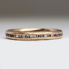 This is our ethereal take on a classic eternity ring. The misty ring features a beautiful range of Montana sapphires interspersed with brown diamonds. The stone colours are natural and no two are quite the same. This ring has a slender and delicate feel, and was made by casting recycled gold in a small mould using Cornish sand. You are welcome to choose the beach sand your ring is cast in. The original design is made in 9ct white gold, however we can make this ring in a gold of a your choice. Ou Hippie Engagement Rings, Delicate Gold Rings, Organic Gold Ring, Montana Sapphires, Sapphire Eternity Ring, Brown Diamonds, Beautiful Range, Contemporary Ring, Montana Sapphire