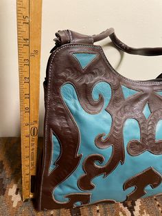 Leaders in Leather Beautifully Cutout Tooled Shoulder Bag - Etsy Turquoise Hand Tooled Rectangular Shoulder Bag, Turquoise Hand Tooled Travel Bag, Artisan Blue Leather Bag, Handmade Turquoise Shoulder Bag, Turquoise Hand Tooled Shoulder Bag For Travel, Blue Leather Artisan Shoulder Bag, Artisan Blue Leather Shoulder Bag, Blue Artisan Leather Shoulder Bag, Hand Tooled Blue Bags For Daily Use