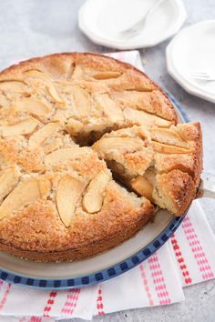 an apple pie on a plate with one slice cut out and the rest sliced off