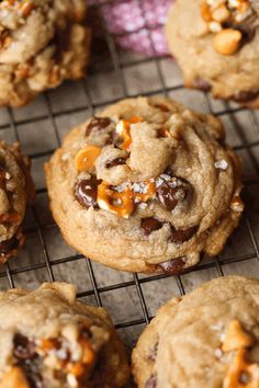 chocolate chip cookies on a cooling rack with orange peels and chopped walnuts in the middle