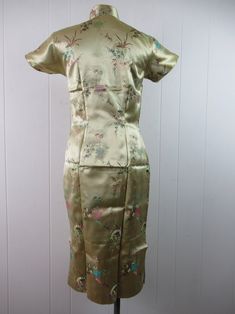 "Vintage 1960s Asian design dress. Made of pale yellow green shimmery silk. Has nerd collar and side zipper. No label. Size medium. Actual measurements are: 36\" around the bust 29.75\" around the waist 38\" around the hips 14.5\" shoulder seam to shoulder seam 44\" overall length In good condition with faint color fade from storage on front." Light Green Fitted Dress With Short Sleeves, Long Vintage Silk Dress, Vintage Long Green Dress, Silk Dress Vintage, 1960s Dress, 1970s Dresses, Asian Design, 1960's Dress, Hawaiian Dress