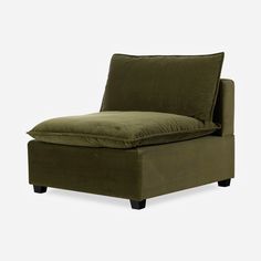 an olive green chaise lounge chair with pillows