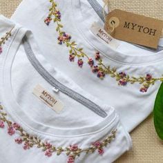 three white t - shirts with embroidered flowers on them