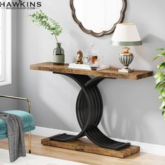 a living room with a mirror, lamp and table in the corner on hardwood flooring