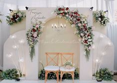 an arch decorated with flowers and greenery is set up for a wedding or ceremony