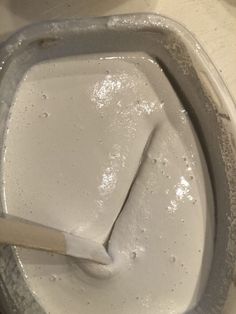 a close up of a white toilet bowl with a brush in it