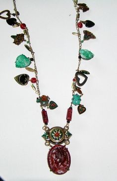 "Popular in the 1970s, this is a \"charm necklace\" Attached to either side of the chain are the same charms or in many instances, different charms.  Charms are set with RS and crystals, are enameled, are semi precious stones, are single prong set RS, beads etc. The pendant is hung from a partially enameled connector set with crystals and a semi precious stone. The pendant is a molded glass cameo. Measures:  Chain - 28\" long  Entire pendant - 3 1/4\" by 1 1/2\"" Vintage Charm Necklace With Dangling Pendants, Vintage Pendant Charm Necklace With Dangling Charms, Vintage Charm Necklace With Dangling Charms For Jewelry Making, Vintage Charm Necklaces With Dangling Charms For Jewelry Making, Vintage Metal Charm Necklace, Unique Metal Necklaces With Dangling Charms, Vintage Pendant Necklaces With Dangling Charms, Vintage Enamel Charms Jewelry, Vintage Charm Pendant Necklace