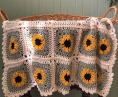 a crocheted blanket with sunflowers on it