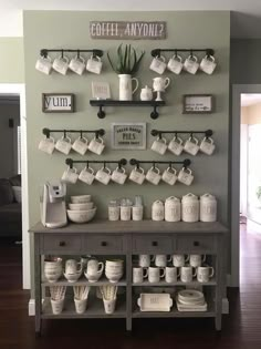 a coffee bar with cups and mugs on it