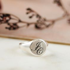 A personalised solid silver engraved initial ring makes a timeless essential piece of jewellery to treasure. A unique custom engraved solid silver signet ring that's perfect for a landmark birthday, such as 18th or 21st birthday gift for a son or grandson. The silver ring is solid silver, the back is not hollow, it's solid throughout, and hallmarked in the UK for your assurance of quality.  Initials are laid out in gently overlapping script fonts. CHOOSE YOUR FINISH Choose to have your signet ri Minimalist Engraved Ring With Initials For Anniversary, Timeless Initial Ring In Sterling Silver As A Gift, Timeless Sterling Silver Initial Ring As Gift, Minimalist Signet Ring With Initials For Anniversary, Initials Engraved White Gold Ring, Minimalist Monogram Engraved Ring For Anniversary, Silver Initial Ring With Oval Shape, Minimalist Sterling Silver Ring With Initials Engraved, Minimalist Sterling Silver Ring With Initials