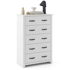 a white dresser with black handles and drawers