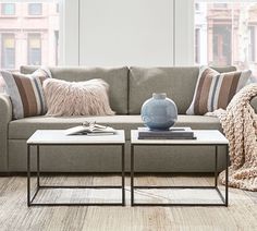 a living room scene with focus on the couch and coffee table in the foreground