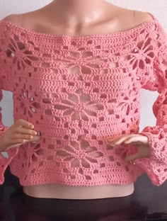 a pink crocheted top on a mannequin's head and torso