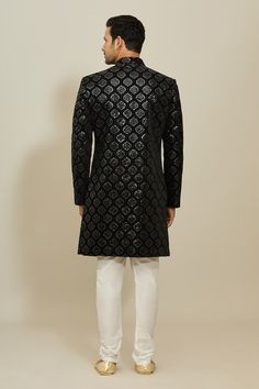 Black sherwani with all over Mughal ogee pattern, thread and sequin embroidery. Paired with a white churidar. - Aza Fashions Black Traditional Wear With Chikankari Embroidery For Reception, Black Nehru Jacket With Zari Work, Black Bandhgala With Chikankari Embroidery Bollywood Style, Fitted Brocade Sherwani With Dabka Work, Black Bandhgala With Chikankari Embroidery For Transitional Season, Festive Black Bandhgala With Chikankari Embroidery, Fitted Black Bandhgala Straight Kurta, Black Straight Kurta Sherwani With Zari Work, Black Sherwani With Chikankari Embroidery