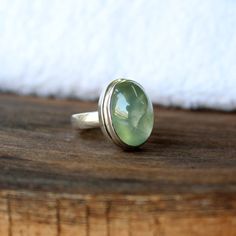 Natural Prehnite ring, Real Sterling Silver ring, cocktail ring, alternative engagement ring, avant garde, birthstone ring, prehnite jewellery Description: Be assured that the product you order is MADE JUST FOR YOU and is not a mass produced item. The gemstone is a OVAL shaped PREHNITE GEMSTONE SIZE-16*12 mm. You have an option to choose a gem for yourself from a set of the stones. Please ask. The rest of the ring is made from 925 STERLING SILVER i.e 92.5% pure silver. And it DOESN'T HAVE ANY LE Green Sterling Silver Amethyst Ring For Wedding, Green Moonstone Ring For Anniversary, Unique Oval Birthstone Gemstones, Unique Oval Birthstone Ring, May Birthstone Rings In Oval Cabochon Shape, May Birthstone Oval Cabochon Rings For Gift, Artisan Gemstone Rings For Anniversary, Unique Green Moonstone Ring For Anniversary, Unique Gemstone Toe Ring