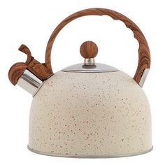 a white tea kettle with wooden handles