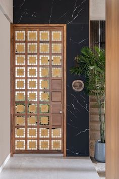 an open door leading into a room with black walls and marble flooring on either side