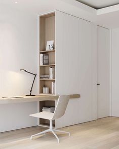 a white chair sitting in front of a desk with a book shelf on top of it