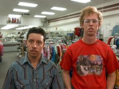 two men standing next to each other in a store