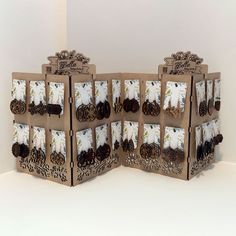 two brown boxes with white and black designs on them, one is open to show the inside