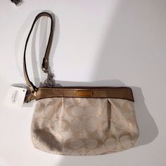 With Tags. Brand New Coach Beige Bag With Zipper Pouch, Coach Clutch Bag With Wrist Strap, Chic Pouch Bag With Wrist Strap, Chic Handheld Bag With Wrist Strap, Chic Beige Bags With Wrist Strap, Elegant Cream Bag With Wrist Strap, Elegant Beige Bag With Wrist Strap, Elegant Beige Bags With Wrist Strap, Coach Pouch Wristlet For Everyday Use