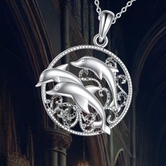 Celebrate friendship, peace, and love with this beautifully designed Dolphin Necklace. Made from durable 925 sterling silver, it features three dolphins swimming together, symbolizing gentleness and spirituality.  The pendant measures 1.34 x 1.03 inches (34.2 x 26.1 mm) and comes with an adjustable 18+2 inch cable chain, making it easy to wear. This unique piece is perfect for those who appreciate ocean life and seek a meaningful accessory. Ocean-inspired Jewelry With Round Pendant For Gift, Ocean-inspired Sterling Silver Necklaces, Ocean-inspired Silver Round Pendant Jewelry, Silver Ocean-inspired Pendant Jewelry, Dolphin Necklace Pendants, Dolphin Necklace, Sea Jewelry, Cable Chain, Dolphins