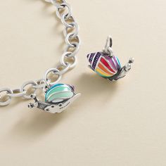 A whimsical addition to your bracelet that is sure to make others smile, this sterling silver, hand-enameled snail charm features several shades of vivid colors (blue, green, orange, purple, red, yellow and white) for a joyful, garden-inspired look. A reminder to slow down and appreciate the small things in life, it pairs well with other colorful, nature-themed designs. Whimsical Multicolor Sterling Silver Jewelry, Playful Multicolor Jewelry With Removable Charms, Multicolor Enamel Charms For Gifts, Appreciate The Small Things, James Avery Charm Bracelet, The Small Things In Life, Small Things In Life, James Avery Charms, Colorful Nature