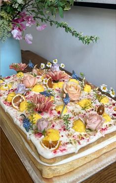 a cake with flowers and lemon slices on it