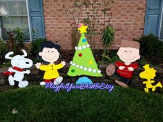 three cartoon characters are standing in front of a christmas tree