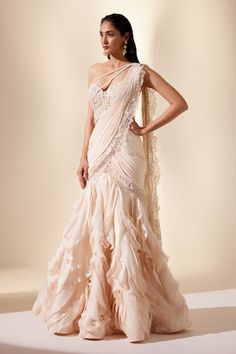 Ivory ruffled pre-draped saree with lace and fringe details. Paired with a floral applique sequin and cutdana embroidered blouse. - Aza Fashions Ruffle Sarees, Ruffle Saree, Drape Saree, Saree Blouse Designs Latest, Dupion Silk, Beaded Neckline, Blouse Designs Latest, Ivory Silk, Blouse For Women