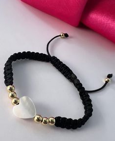 a bracelet with two white hearts on it