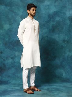 VASTRAMAY Men's Cream And White Cotton Blend Kurta Pyjama Set Look effortlessly stylish in this classic cream and white kurta pyjama set from VASTRAmay. Made from a comfortable cotton blend, this set features a knee-length kurta with a mandarin collar and long sleeves, and white solid pyjama pants with a drawstring closure. Key Features Cream and white color combination Cotton blend fabric for comfort Mandarin collar kurta with long sleeves White solid pyjama with drawstring closure Specificatio Off White Cotton Kurta With Naqshi Detailing, Cotton Kurta In Off White With Naqshi Detail, Off White Cotton Kurta With Dabka, Cream Cotton Kurta With Naqshi Detailing, Traditional Long Sleeve Kurta For Loungewear, Cream Cotton Straight Kurta, Cotton Straight Kurta For Loungewear, White Cotton Sherwani With Long Sleeves, White Cotton Sherwani