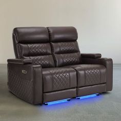 a reclining leather sofa with blue lights on the armrests and head rest