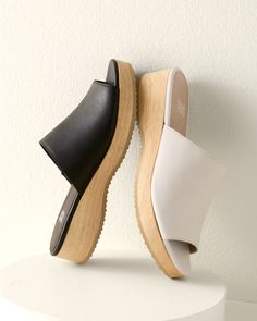 A casual slide in rich leather with a slight wedge, for an everyday slip-on that's a touch above the rest. Well crafted with comfy padding and a sustainable-wood base.  By EILEEN FISHER. Leather-wrapped padded footbed. Wood wedge and platform. Man-made sole. Comfortable Cushioned Wedge Heel Slides, Leather Wedge Heel Slides With Textured Footbed, Spring Everyday Clogs With Cushioned Footbed, Leather Slides With Textured Footbed And Wedge Heel, Spring Clogs With Cushioned Footbed For Everyday, Modern Leather Footbed Slides With Wedge Heel, Comfortable Leather Footbed Mules With Wedge Heel, Modern Slides With Leather Footbed And Wedge Heel, Comfortable Mules With Cushioned Footbed And Wedge Heel